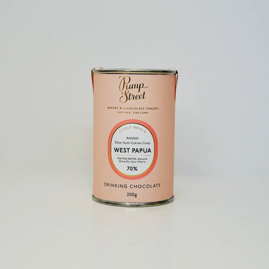 Can of drinking chocolate from West Papua with a visible brand label on a white background