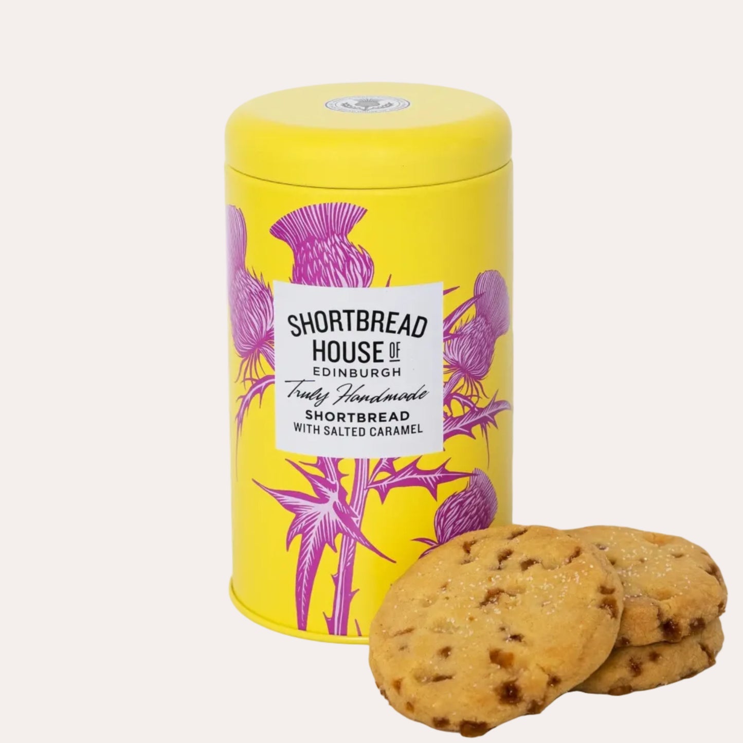Yellow tin of Shortbread House of Edinburgh shortbread cookies with thistle design on a white background
