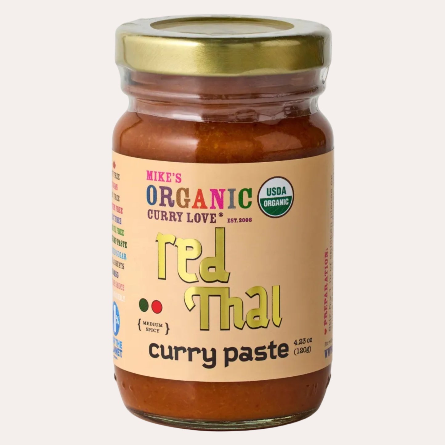 Jar of Mike's Organic Red Thai Curry Paste with a gold lid on a white background
