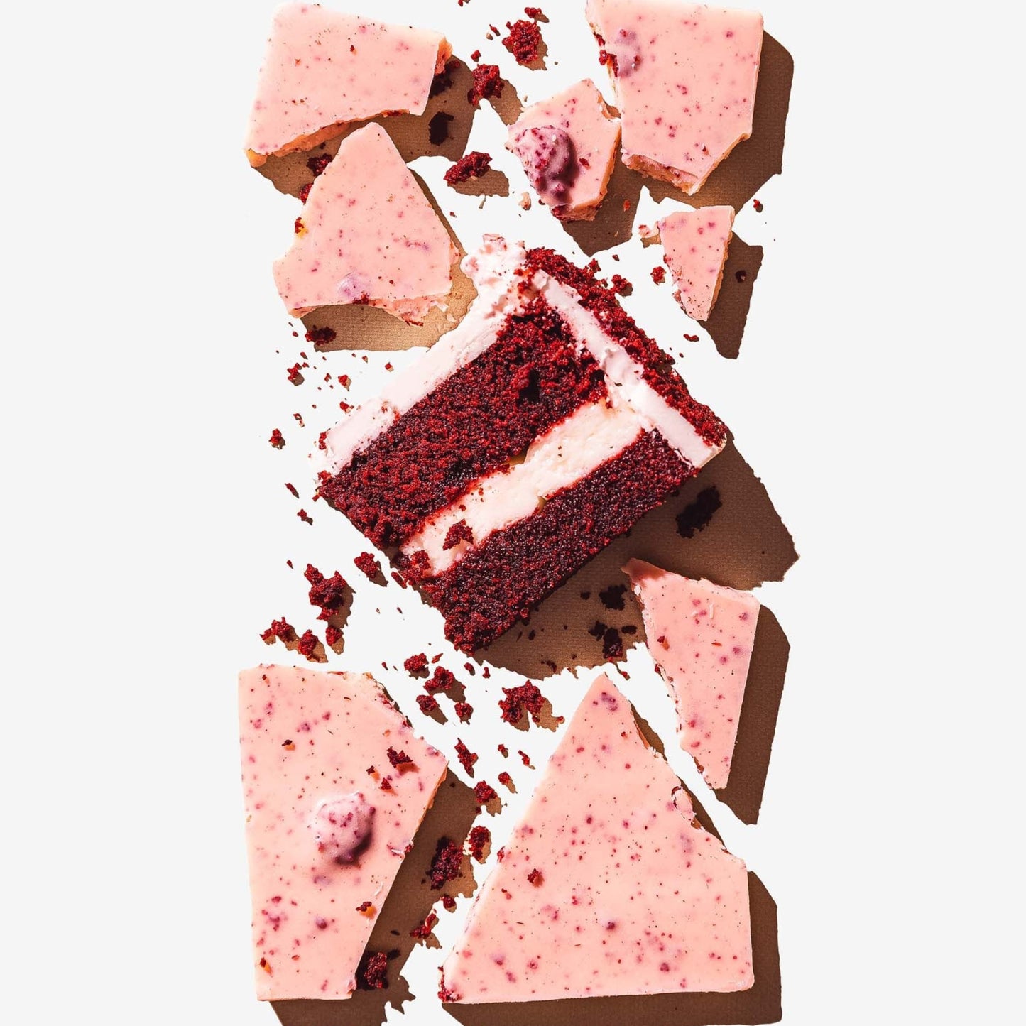 Red velvet cake with cream cheese frosting on a white background