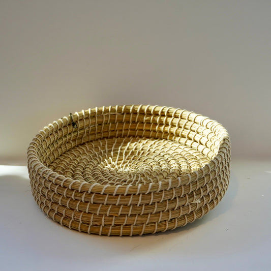 Woven basket on a white surface with a light gray background