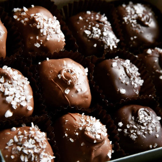 Close-up of chocolate truffles with sea salt on a dark background