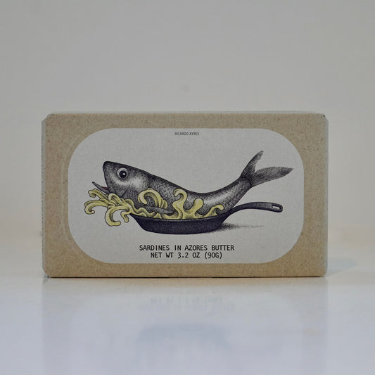 Cardboard box with tinned fish inside with fish illustration and text on a white background