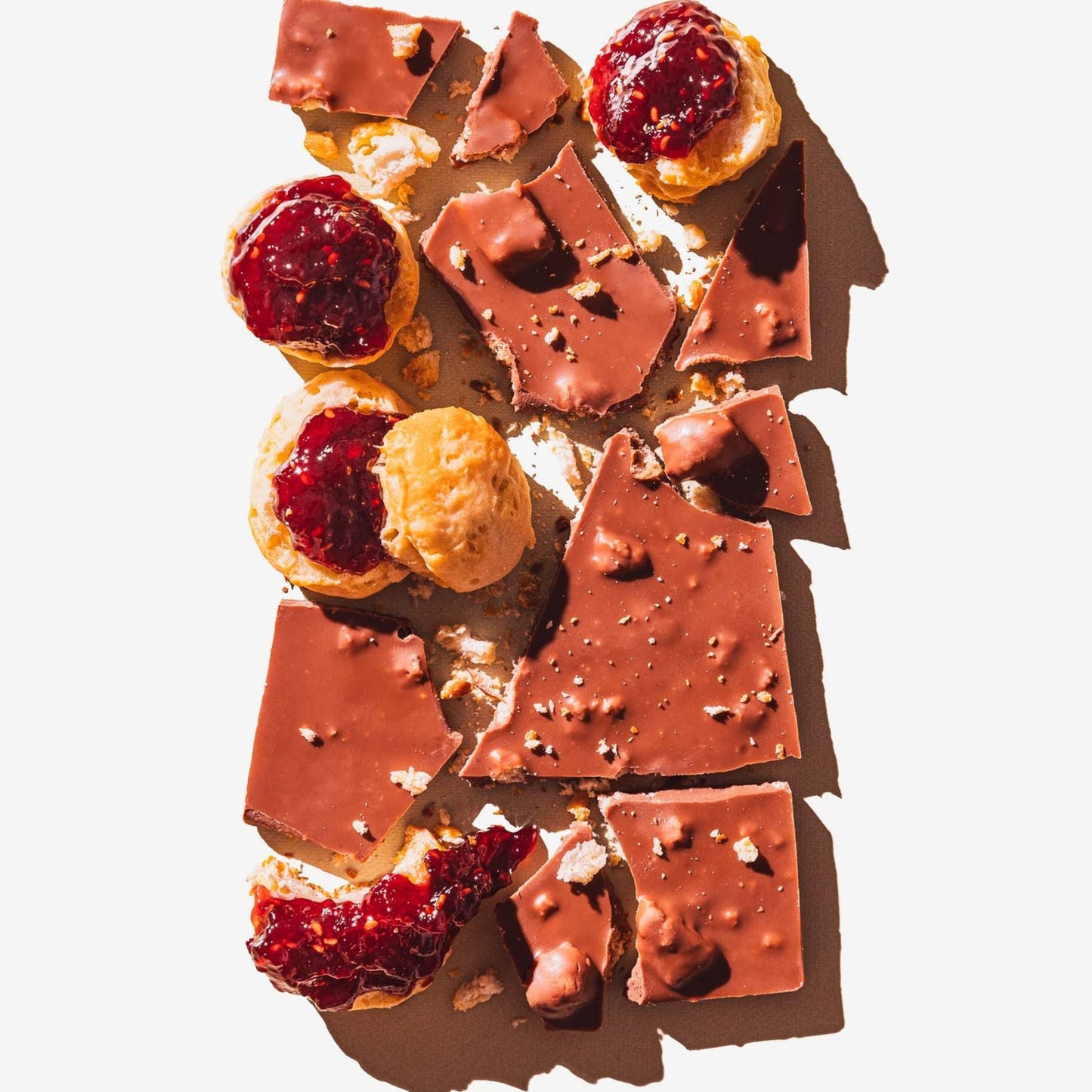 Chocolate pieces with toppings on a white background