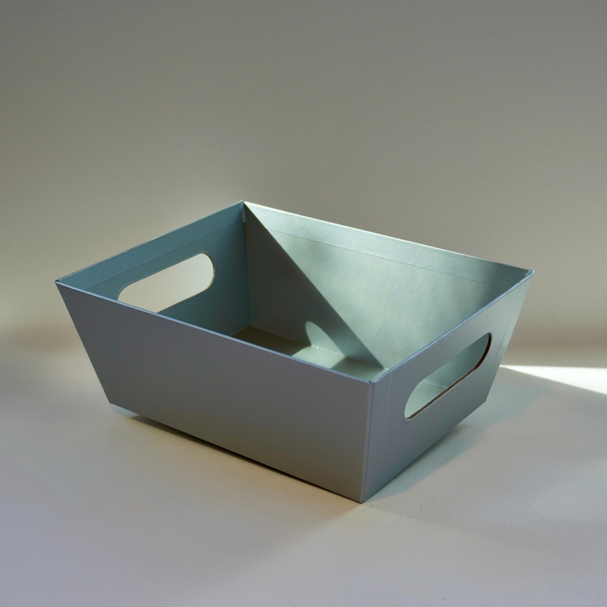 Gray rectangular tray on a light gray background
