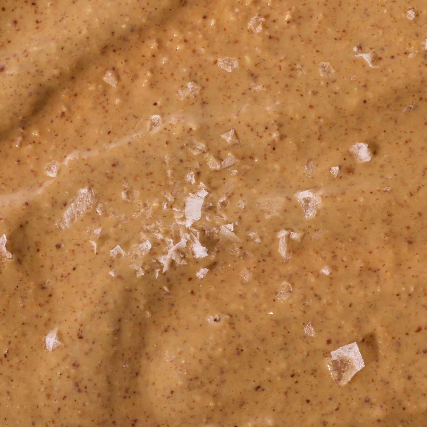 Close-up of a creamy peanut butter texture with visible chunks
