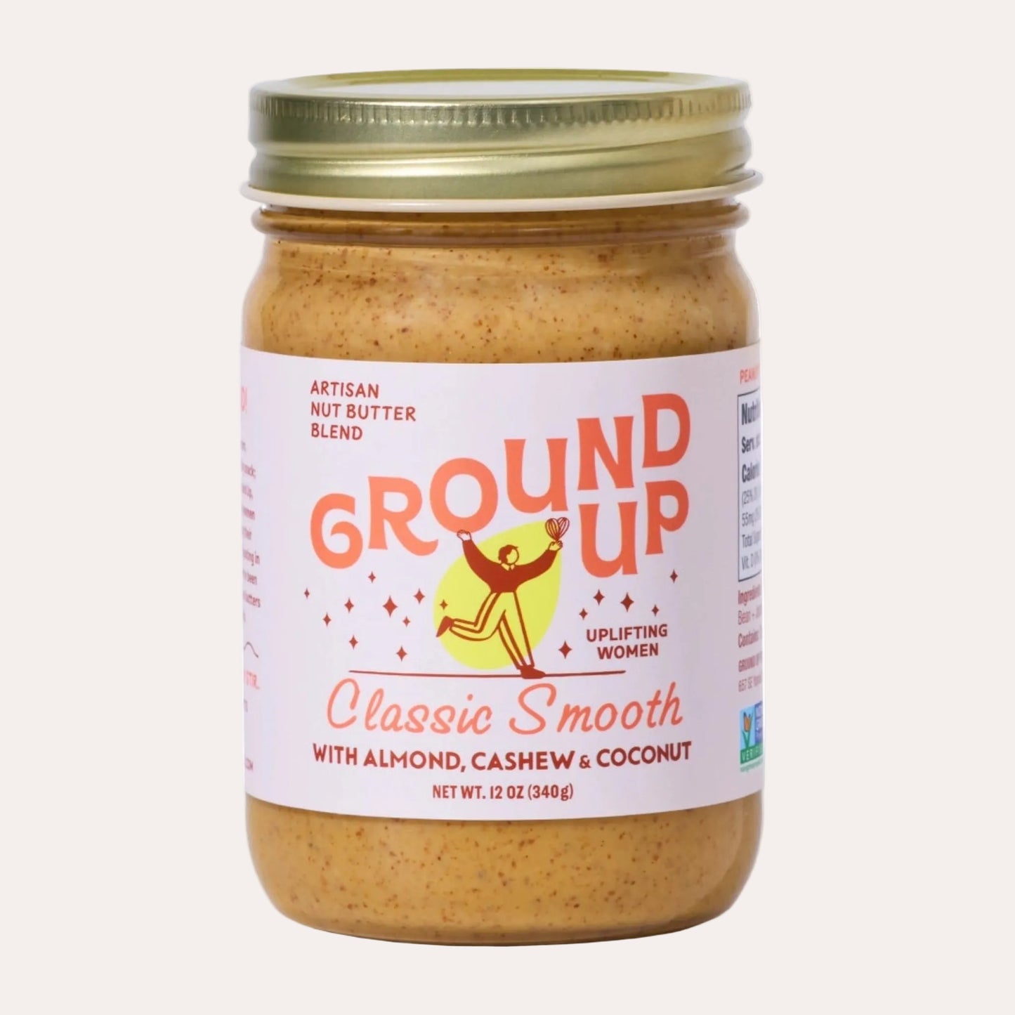 Jar of Ground Up nut butter with a white label on a white background