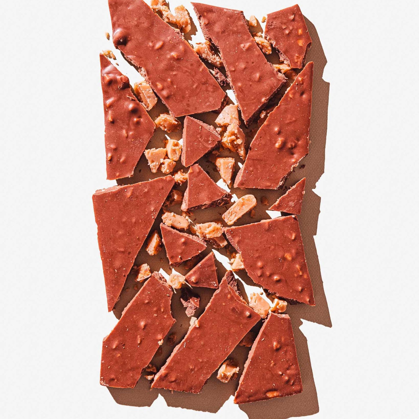 Chocolate pieces with nuts on a light background