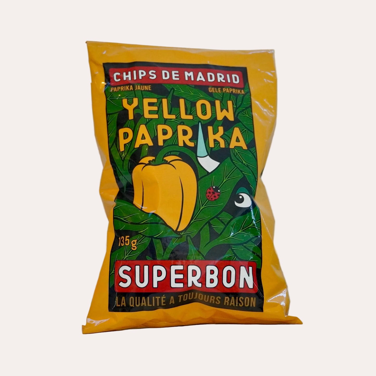 Yellow paprika packaging with green leaf design on a white background