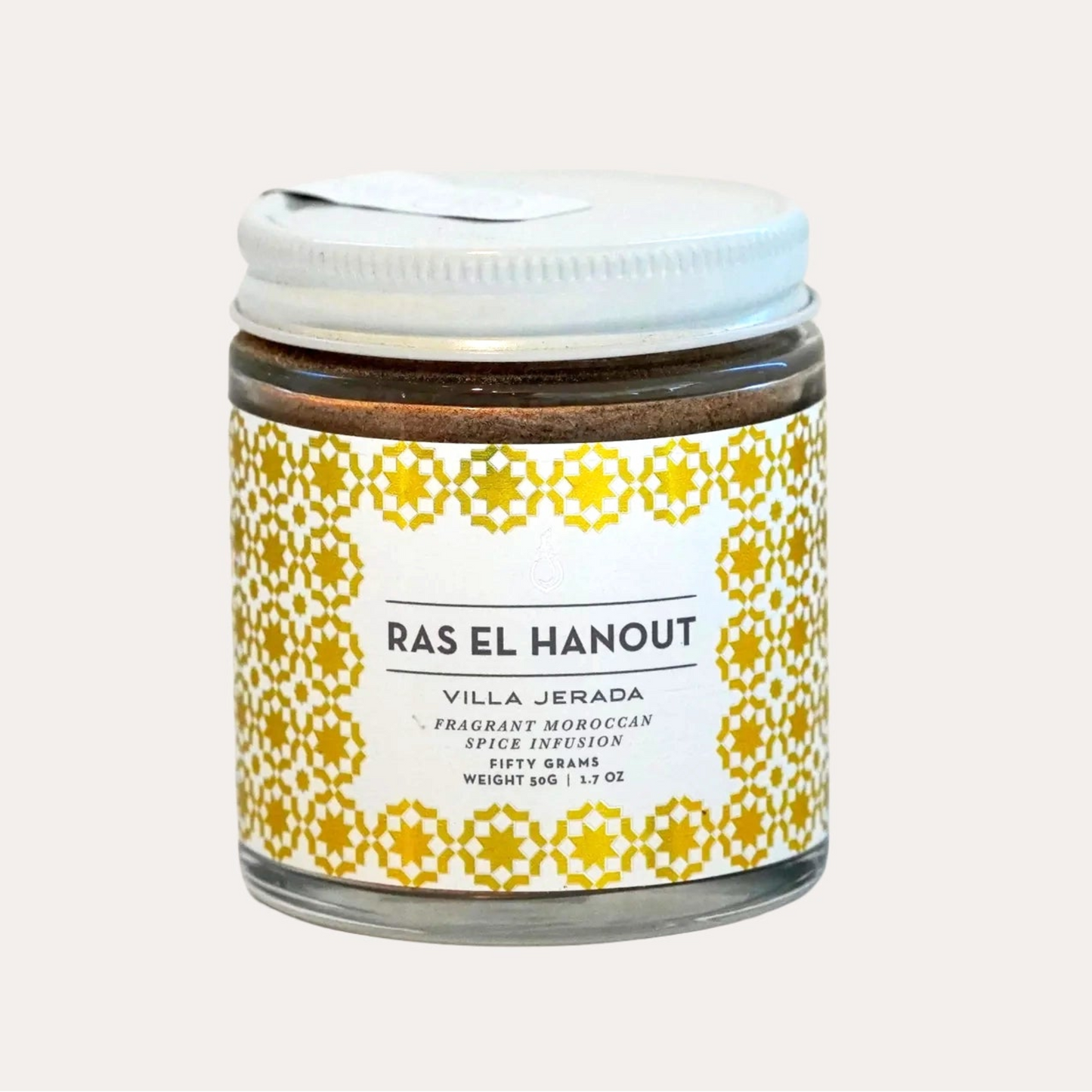 Jar of Ras El Hanout with a decorative label on a light gray background