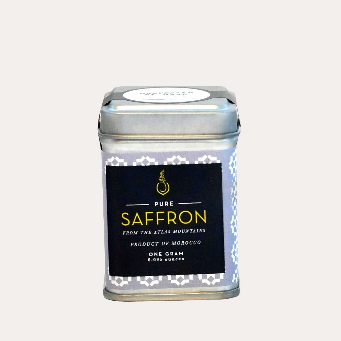 Small metal tin labeled 'Pure Saffron' on a white background