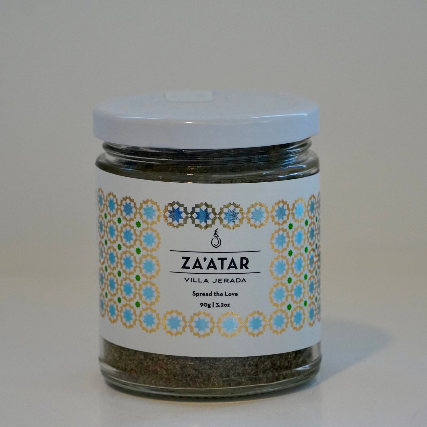 Jar of za'atar with decorative label on a white surface