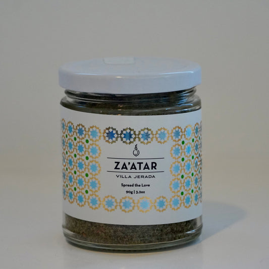 Jar of za'atar with decorative label on a white surface