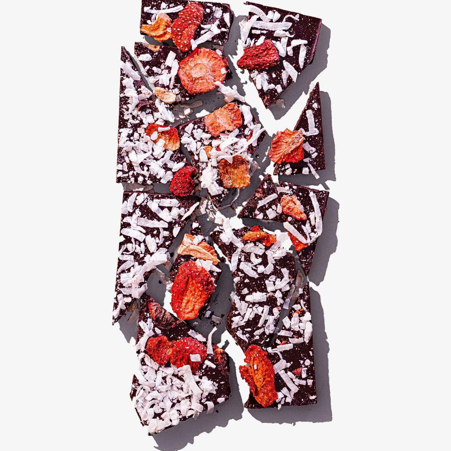 Chocolate bark with dried fruit and coconut on a white background