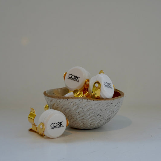 Bowl with cork stoppers on a white background