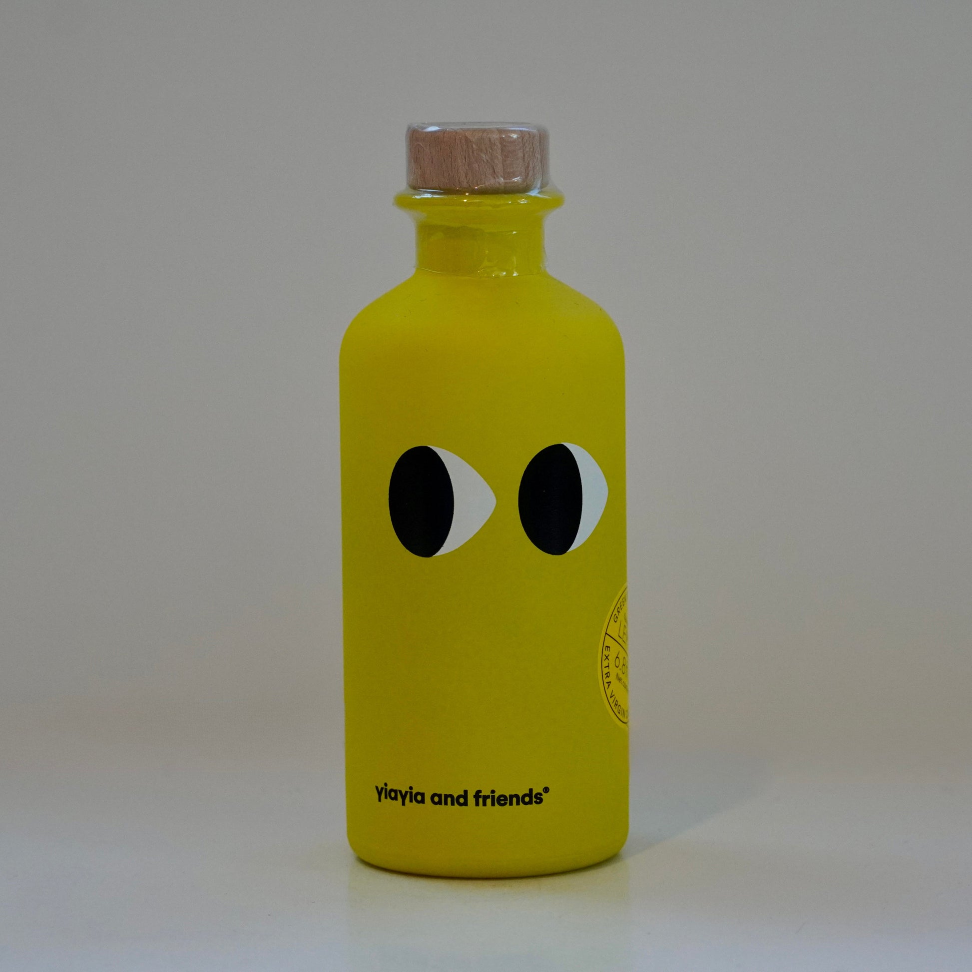 Yellow bottle with black and white eyes on a gray background