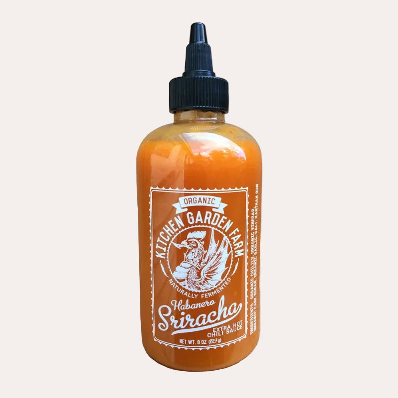 Bottle of Organic Kitchen Garden Farm Habanero Sriracha on a white background