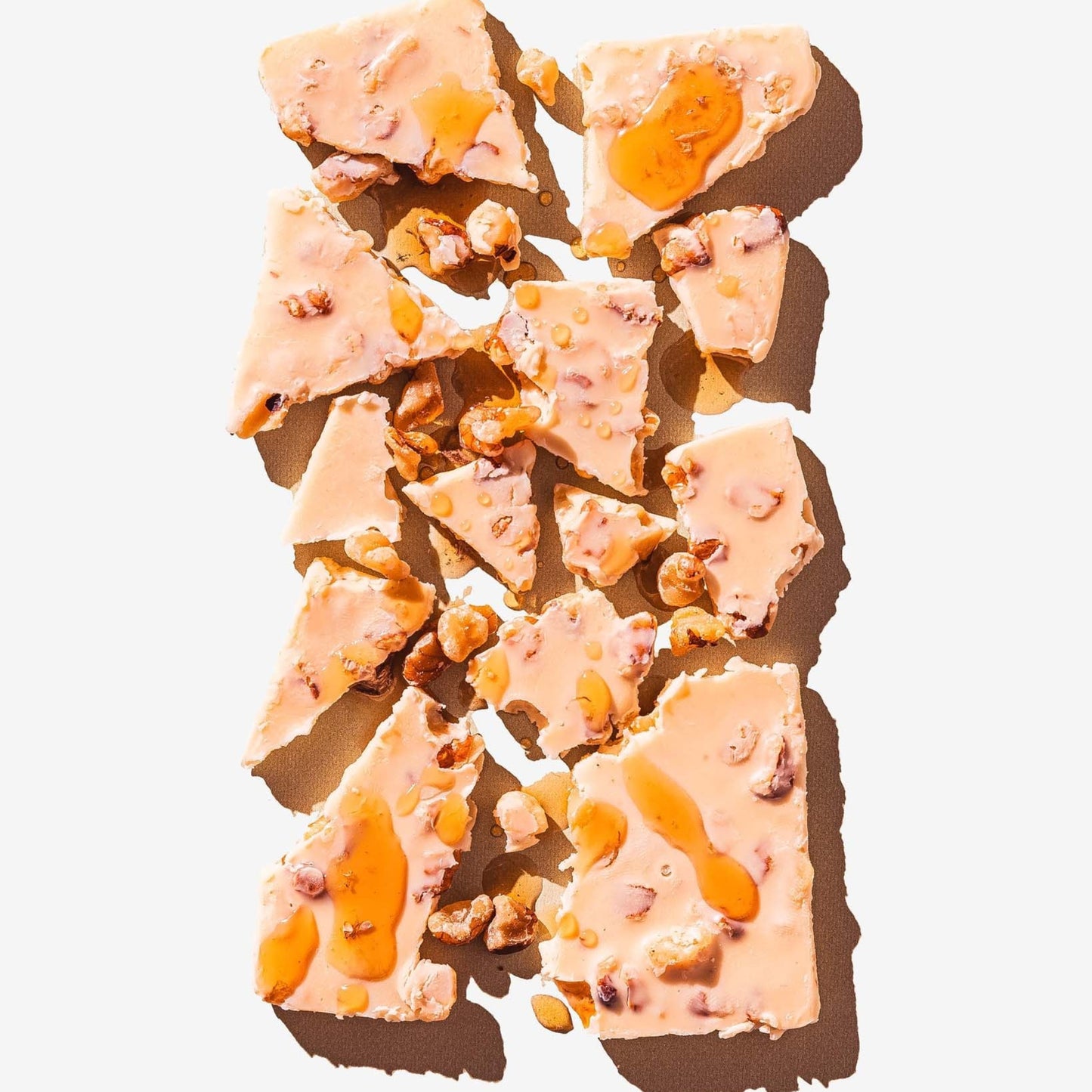 Crispy dessert with orange drizzle on a white background