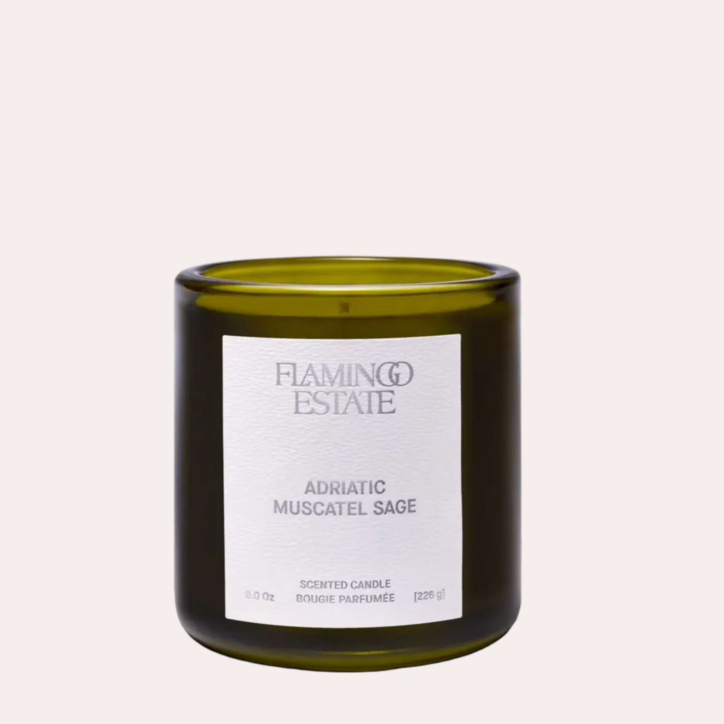 Green candle with a label on a white background